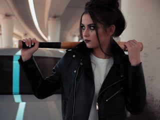 Portrait beautiful girl with baseball bat. Fashion makeup and hair style. 