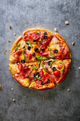 Pizza on a dark gray background  viewed from above. Copy space. Top view