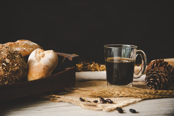 Black coffee in glass is placed on wooden floor - concept still life