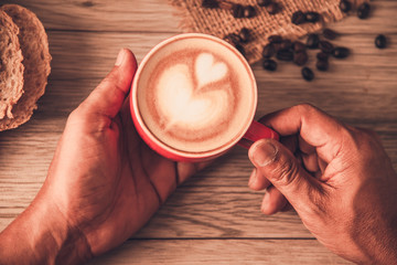 Hand is holding a red cup of coffee. concept still life