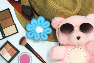 Teddy bear has a lovely pink. Put on black eyewear to make up with cosmetics, have a beautiful yellow hat, white background.