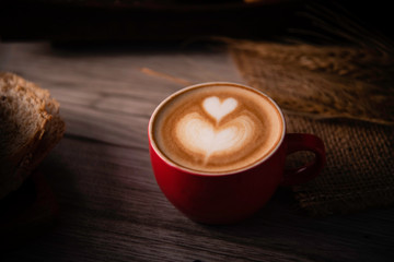 Red coffee glass rests on wood floor. concept still life