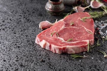 Raw beef steak with spices.