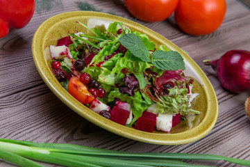 Fresh green salad mix with berries and mint