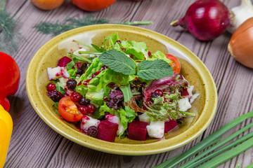 Fresh green salad mix with berries and mint
