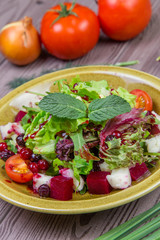 Fresh green salad mix with berries and mint