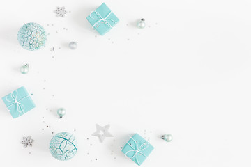Christmas composition. Christmas gifts, blue and silver decorations on white background. Flat lay, top view, copy space