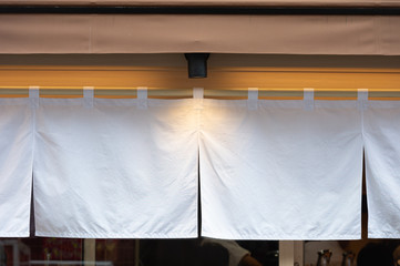 The curtain-like fabric that hangs in front of traditional Japanese restaurants and shops not only serves as a signboard, but holds a larger meaning,