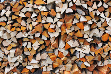 Pile of stacked firewood ready , texture wooden background
