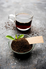 Black Tea Powder or dry dust with or without green leaf and served hot chai in a cup