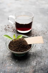 Black Tea Powder or dry dust with or without green leaf and served hot chai in a cup