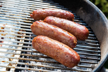 Sausages cook on the grill