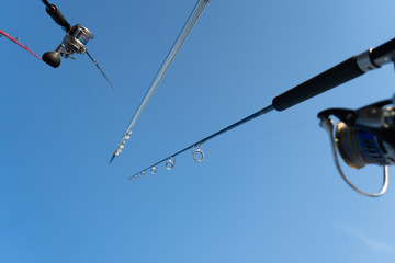 Closeup on fisherman rod on the ocean coast background