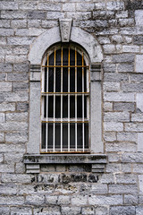 Fototapeta na wymiar old jail window on the wall
