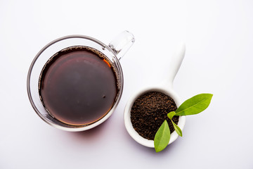 Black Tea Powder or dry dust with or without green leaf and served hot chai in a cup