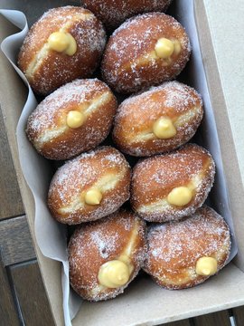High angle image of Italian donuts filled with passionfruit pastry cream