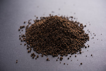 Black Tea Powder or dry dust with or without green leaf and served hot chai in a cup