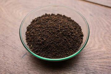 Black Tea Powder or dry dust with or without green leaf and served hot chai in a cup