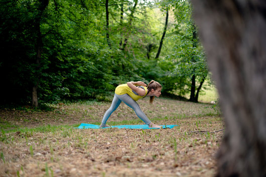 Young woman practicing yoga in the park