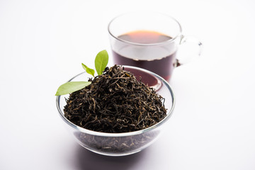 Black Tea Powder or dry dust with or without green leaf and served hot chai in a cup