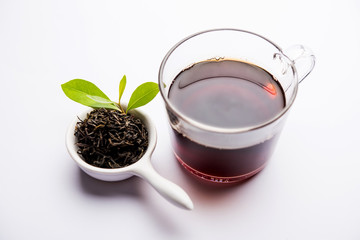 Black Tea Powder or dry dust with or without green leaf and served hot chai in a cup