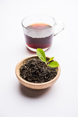 Black Tea Powder or dry dust with or without green leaf and served hot chai in a cup