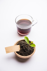 Black Tea Powder or dry dust with or without green leaf and served hot chai in a cup