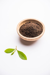 Black Tea Powder or dry dust with or without green leaf and served hot chai in a cup
