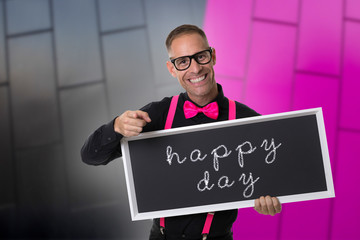 Young boy with black shirt and bow tie and colored suspenders