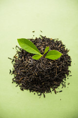Black Tea Powder or dry dust with or without green leaf and served hot chai in a cup