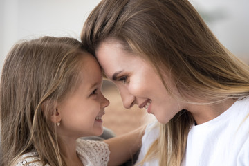 Loving mom and daughter embrace looking in eyes enjoying tender moment together, cute caring mother...