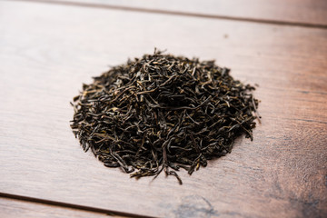 Black Tea Powder or dry dust with or without green leaf and served hot chai in a cup