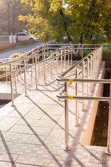 ramp way for support wheelchair .Concret ramp way with stainless steel handrail for support wheelchair disabled people.Barrier-free access.Selective focus.Building entrance