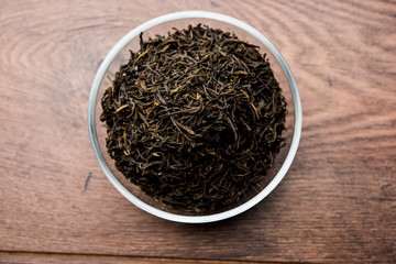 Fototapeta na wymiar Black Tea Powder or dry dust with or without green leaf and served hot chai in a cup