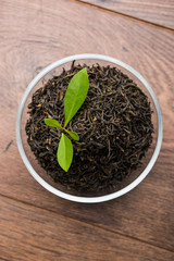 Black Tea Powder or dry dust with or without green leaf and served hot chai in a cup