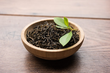 Black Tea Powder or dry dust with or without green leaf and served hot chai in a cup