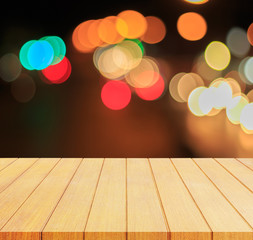 Look out from the wood table, see blurring the lights of cars on the road at night ,A very beautiful bokeh.