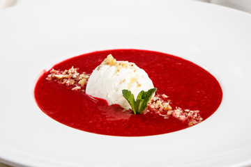 Strawberry soup with ice cream and mint.