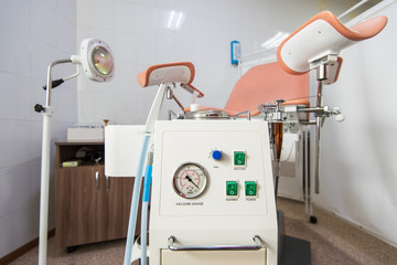 Gynecological cabinet with chair and other medical equipment in modern clinic