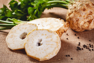 Celery root with leaves on sackcloth background. Close up
