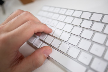 hands typing on laptop keyboard