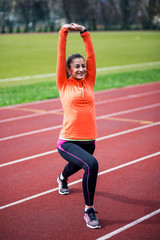 Obraz premium Fitness woman exercising at stadium