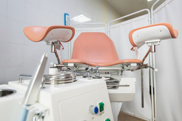 Gynecological cabinet with chair and other medical equipment in modern clinic - obrazy, fototapety, plakaty