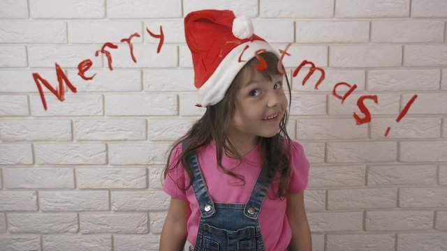 Merry Christmas. Cheerful child in a Santa Claus hat.