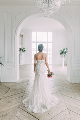 Fototapeta premium Beautiful bride in a white Studio. Russian wedding in St. Petersburg. Portrait and details in fine art style.