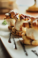 Choux cream on a narrow white plate close-up