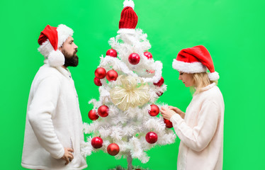 Merry Christmas&Happy New year. Young couple celebrating Christmas at home. Winter holiday and New year. Happy couple getting ready to celebrate Christmas or New Year. Happy family decorating fir-tree