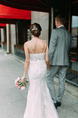 Fototapeta premium Stylish wedding in St. Petersburg. Walking photo shoot in the city. European style of architecture