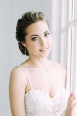 Beautiful bride in a white Studio. Russian wedding in St. Petersburg. Portrait and details in fine art style.