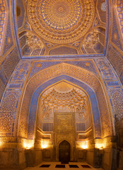 Fototapeta na wymiar Interior of mosque dome with gold gild of Tile Karl Madrasa in The Registan, Samarkand, Uzbekistan